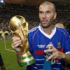 France’s Zinedine Zidane holds the World Cup trophy after an exhibition soccer match in Saint Denis